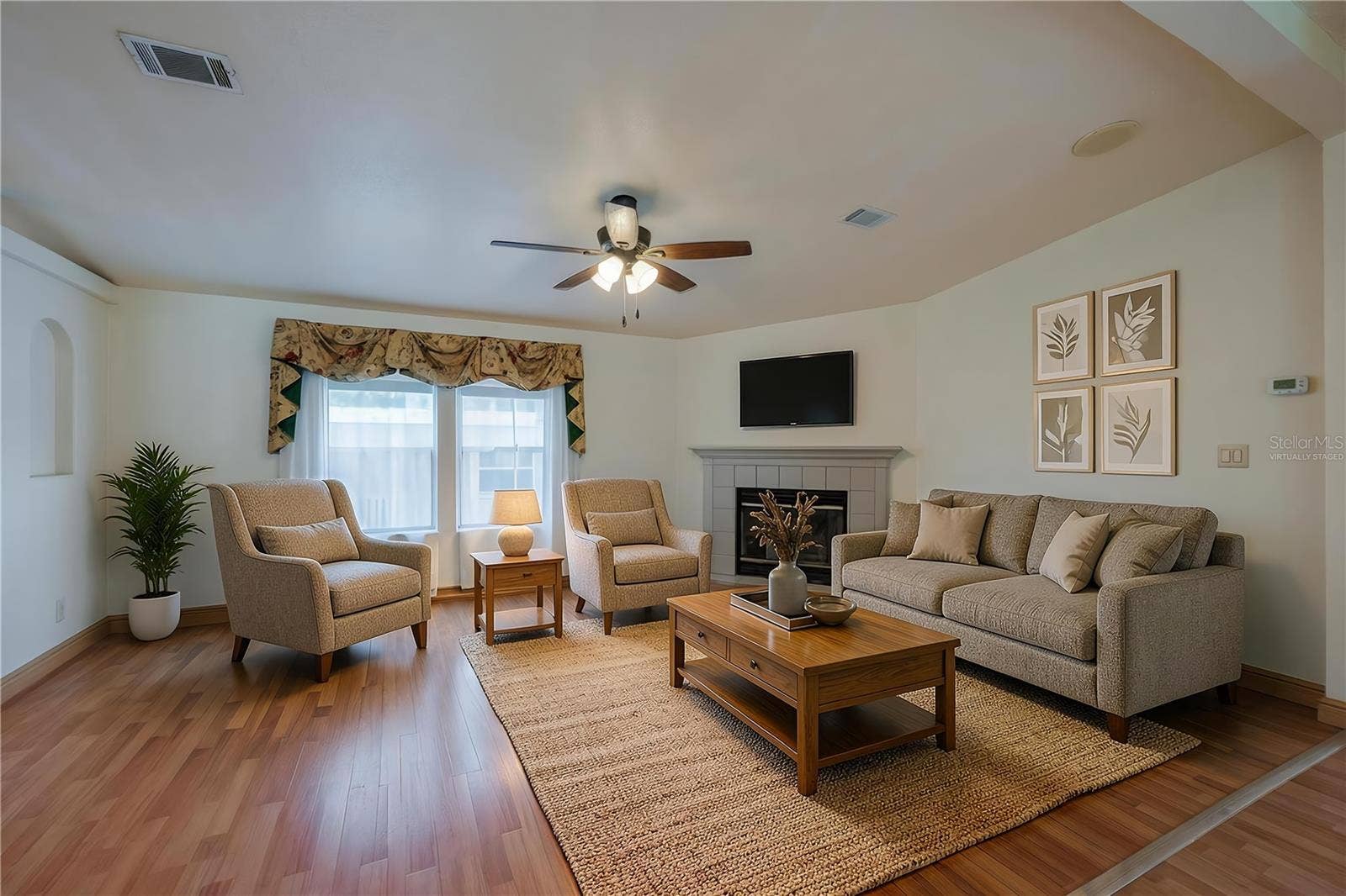 13 LAWRENCE COURT, Port Orange, FL 32127 Virtually Staged...Bright living room offers plenty of flexibility for seating and entertaining, with a fireplace, ceiling fan, and large front-facing windows.