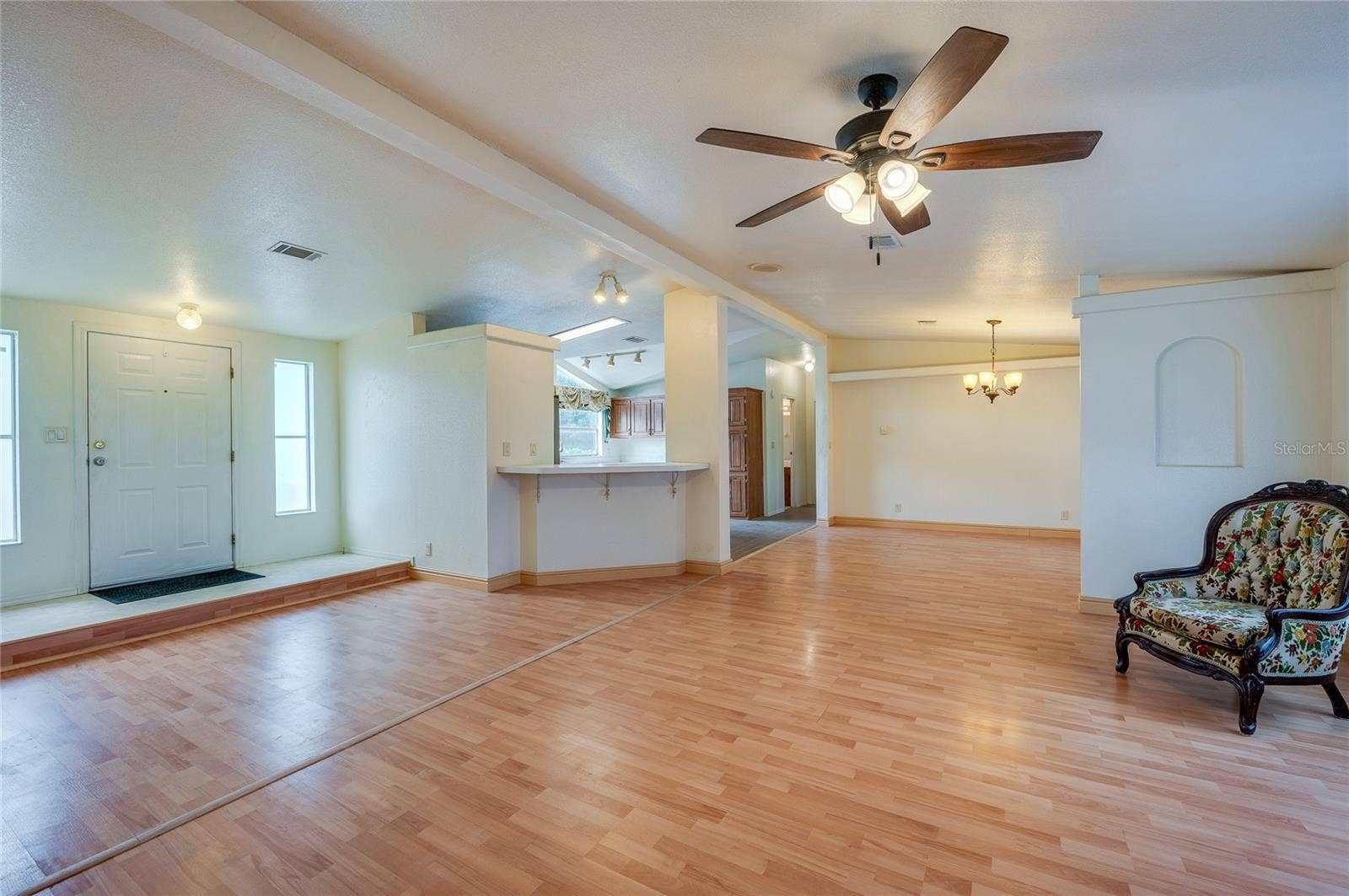 13 LAWRENCE COURT, Port Orange, FL 32127 An expansive main living space connects the living room, dining area, and kitchen, creating a versatile layout for everyday living and entertaining.