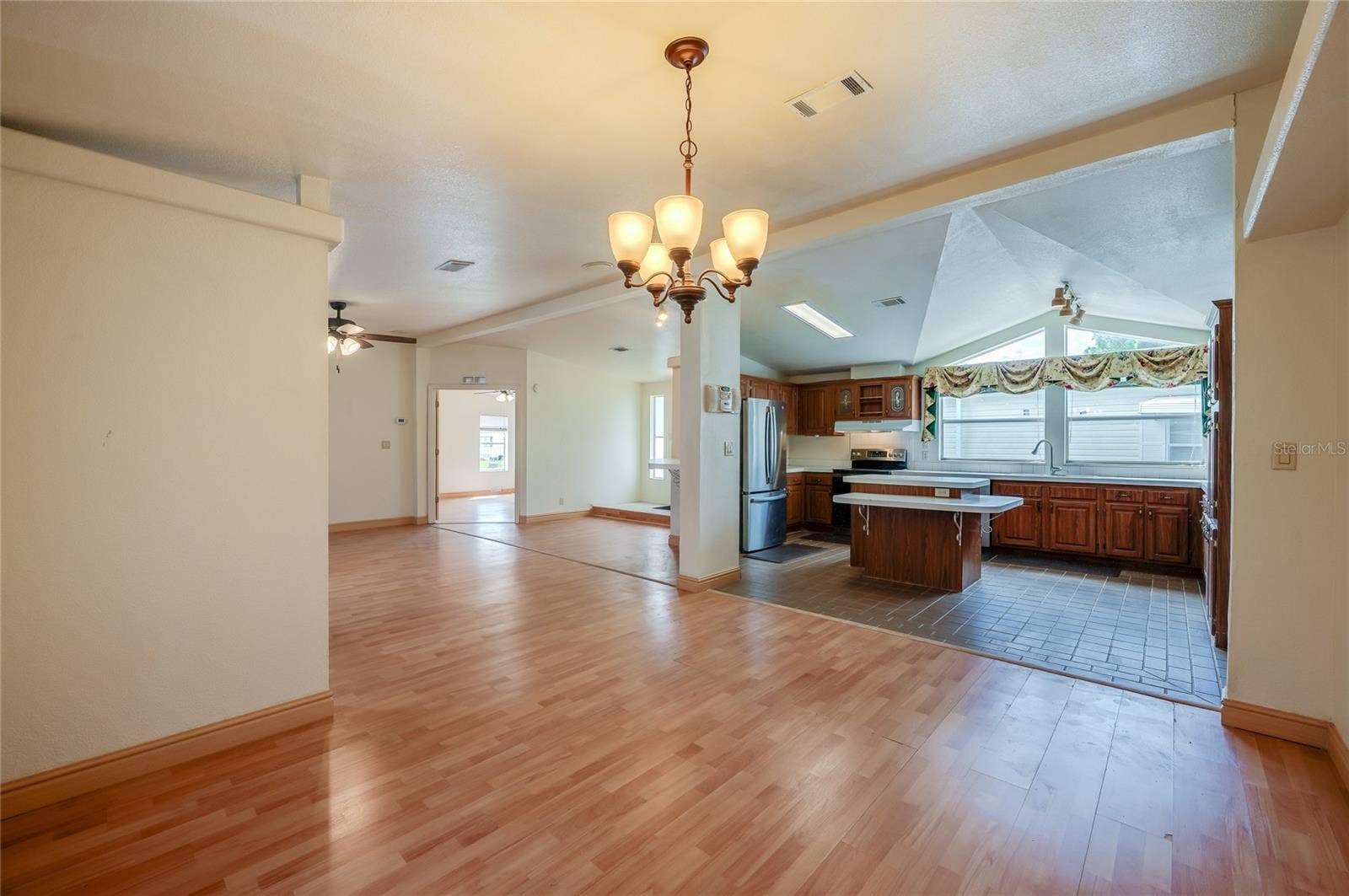 13 LAWRENCE COURT, Port Orange, FL 32127 Open sightlines connect the dining area to the spacious kitchen, creating an easy flow between meal preparation, dining, and the main living space.