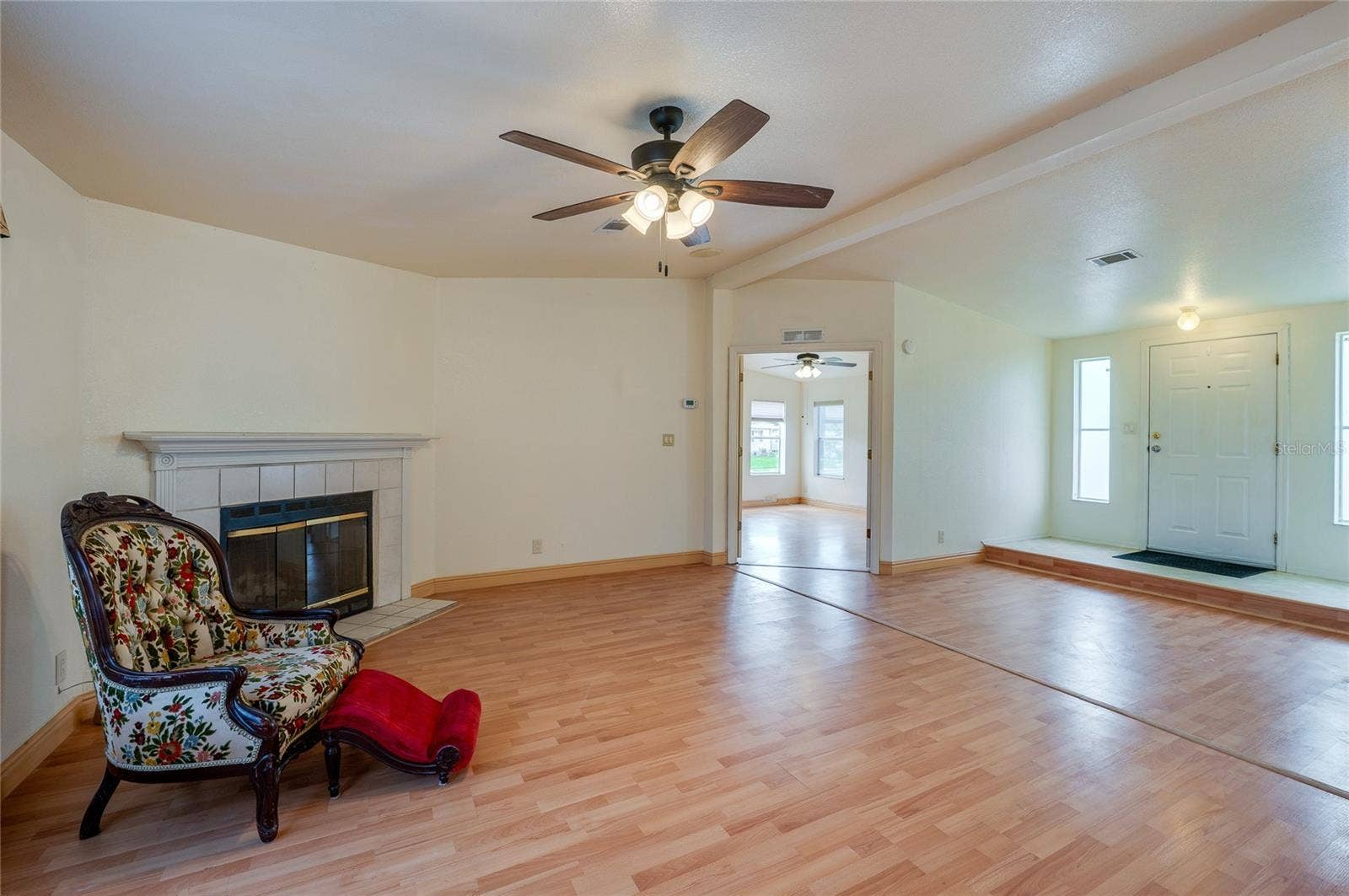 13 LAWRENCE COURT, Port Orange, FL 32127 This angle showcases the home's open interior flow, with the fireplace anchoring the living room and the raised entry positioned just beyond.