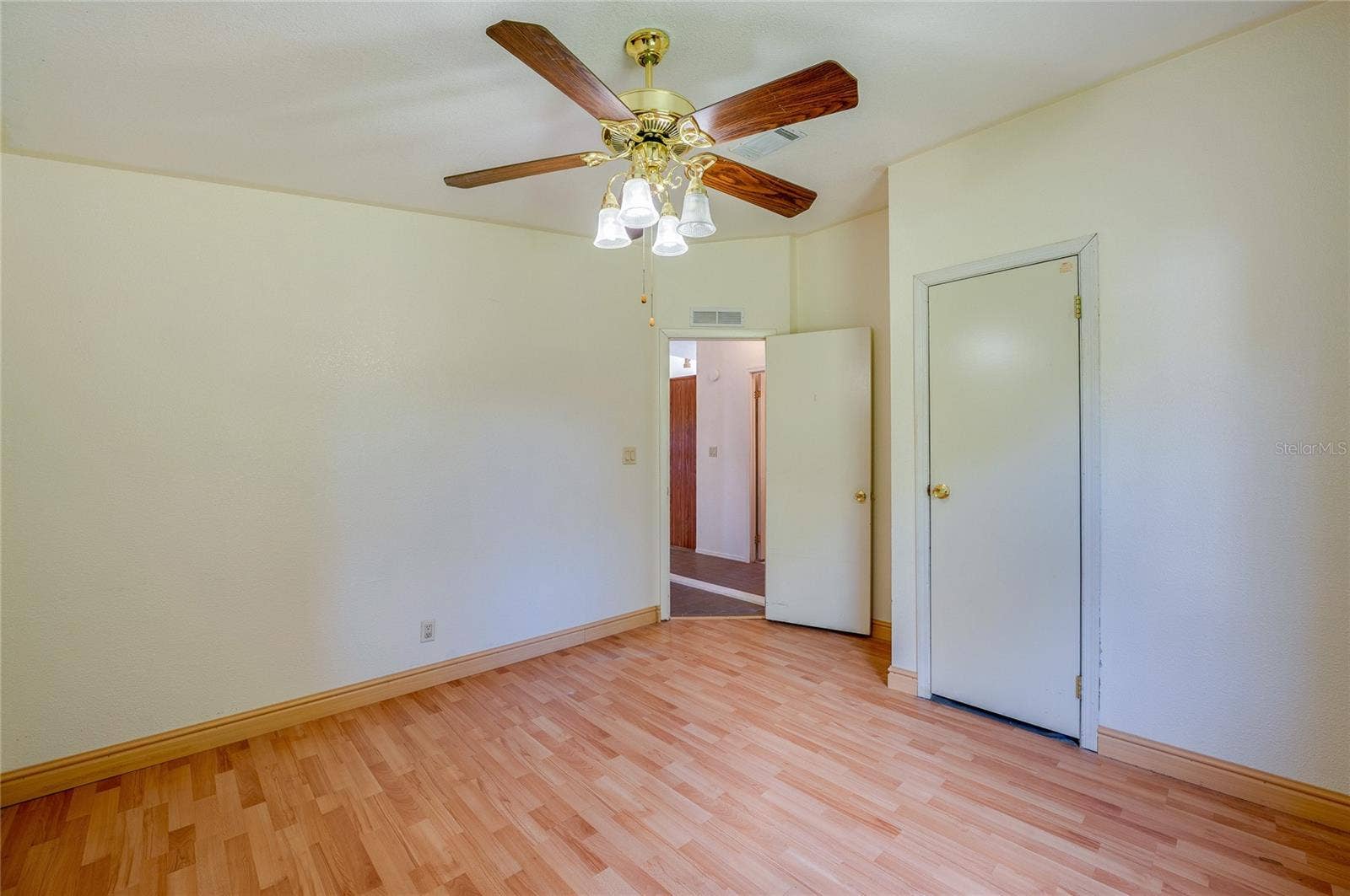 13 LAWRENCE COURT, Port Orange, FL 32127 Alternate view highlights the rooms comfortable proportions, ceiling fan, and convenient closet storage.