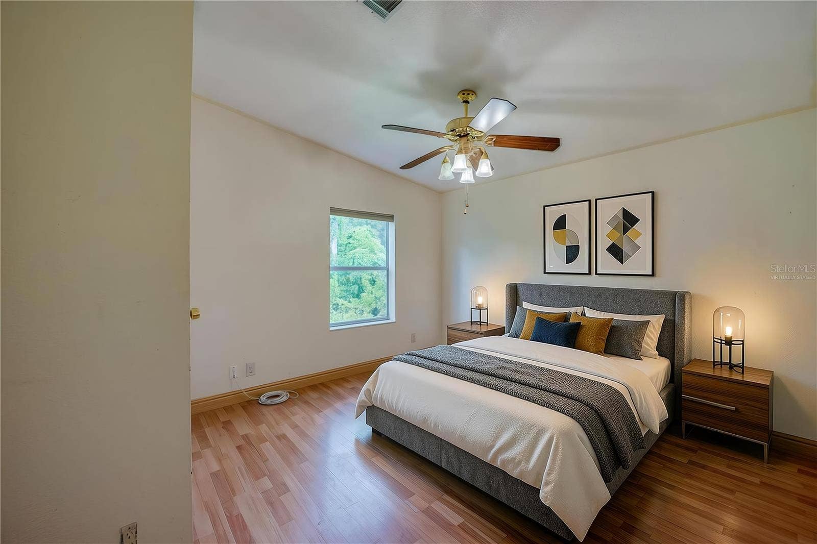 13 LAWRENCE COURT, Port Orange, FL 32127 Virtually Staged...Spacious bedroom offers a ceiling fan, natural light from a large window, and ample wall space for flexible furniture placement.