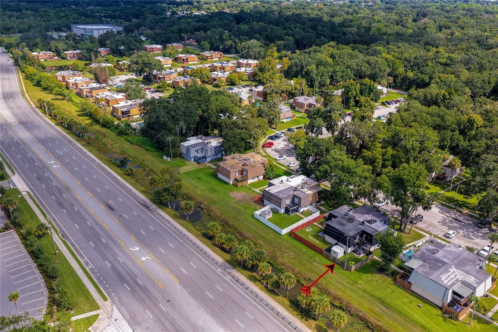 36 SPRINGWOOD SQUARE, Port Orange, FL 32129 High-altitude aerial capture highlighting the unit's proximity to main roadways, neighboring communities, and dense greenery.