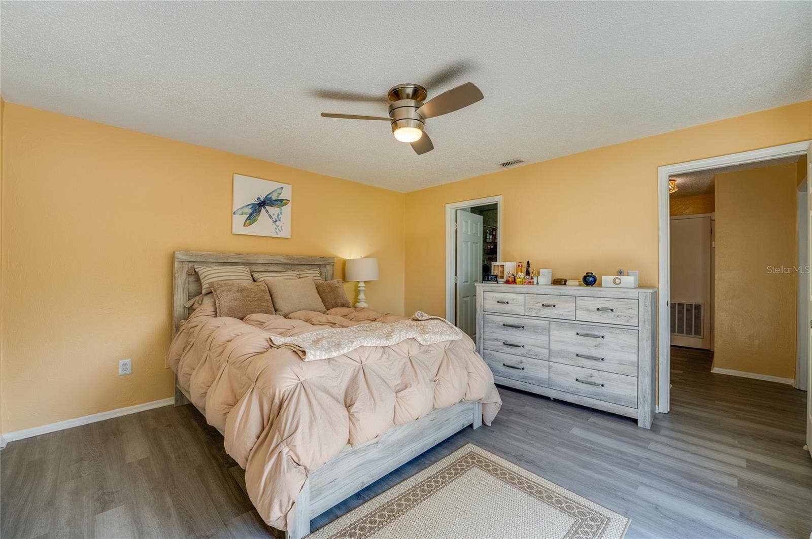 36 SPRINGWOOD SQUARE, Port Orange, FL 32129 Well-lit room highlights modern vinyl plank flooring, neutral walls, and a ceiling fan.