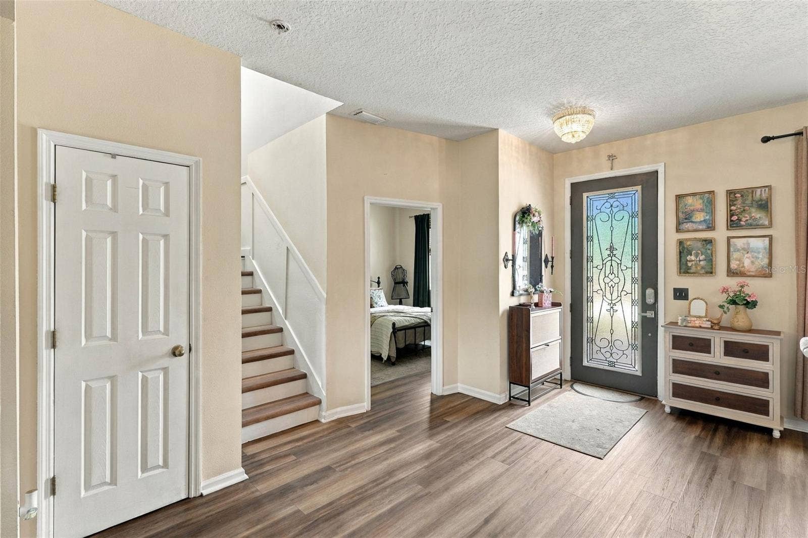 8 ANGELA DRIVE, Palm Coast, FL 32164 Front door afar, bonus room center, stairwell to 2nd floor left.
