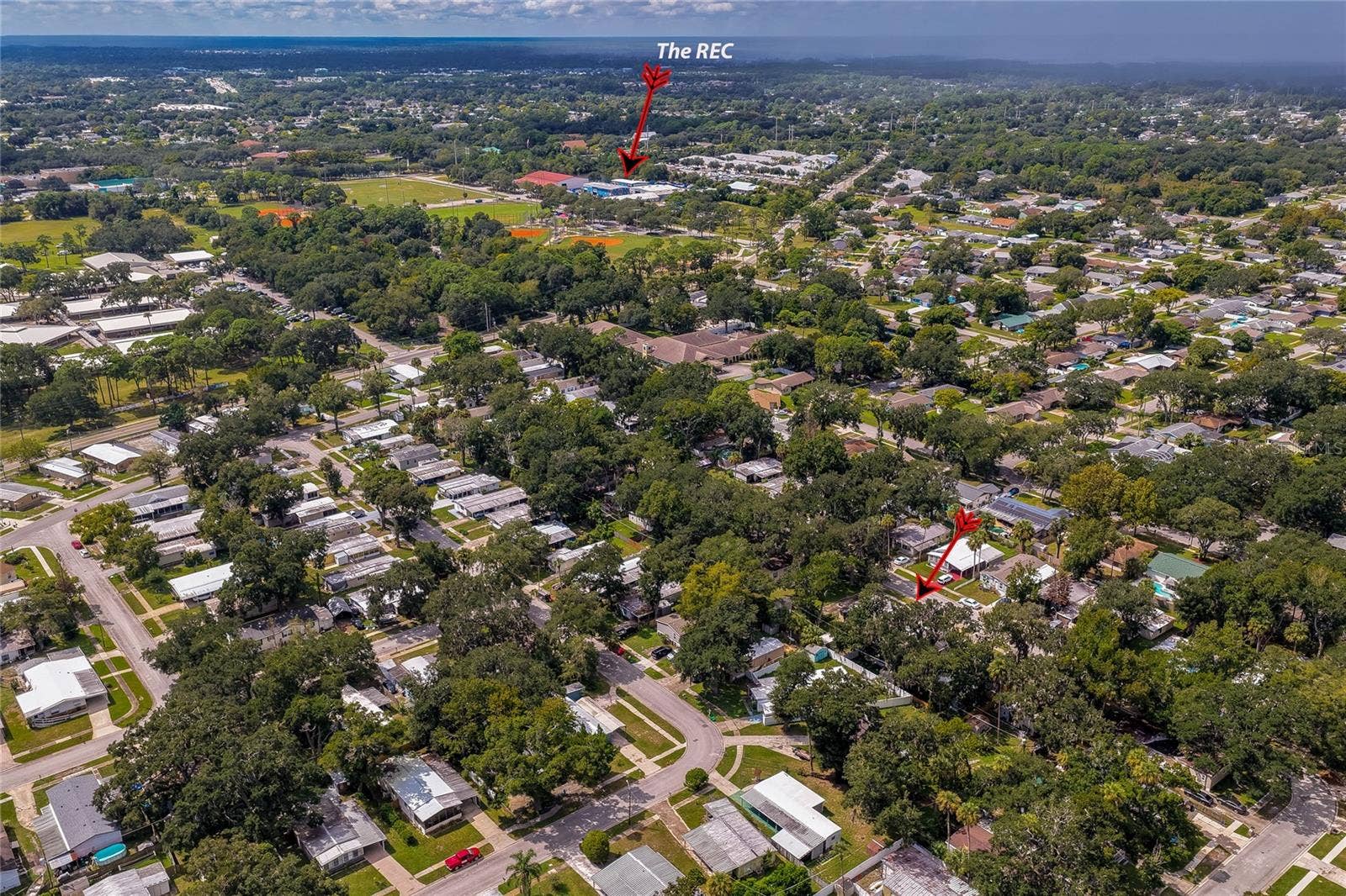 60 GOLDEN GATE CIRCLE, Port Orange, FL 32129 High-angle neighborhood aerial highlighting the property's proximity to local recreational facilities.