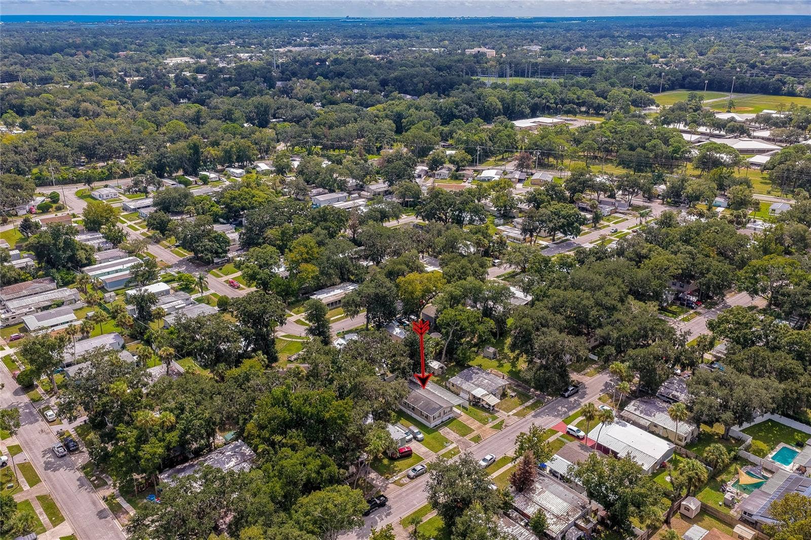 60 GOLDEN GATE CIRCLE, Port Orange, FL 32129 High-altitude aerial shot displaying the property's location within the surrounding tree-lined neighborhood community.