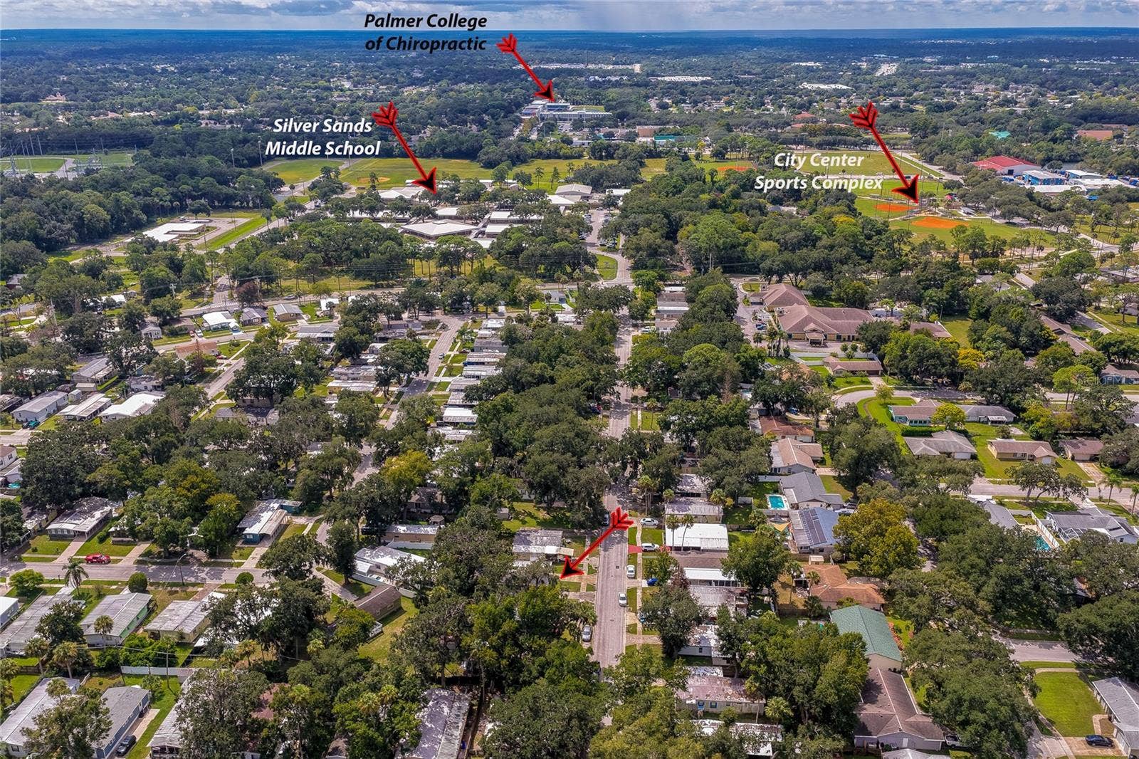 60 GOLDEN GATE CIRCLE, Port Orange, FL 32129 Broad aerial view pointing out local community landmarks including Silver Sands Middle School, Palmer College of Chiropractic, and the City Center Sports Complex.