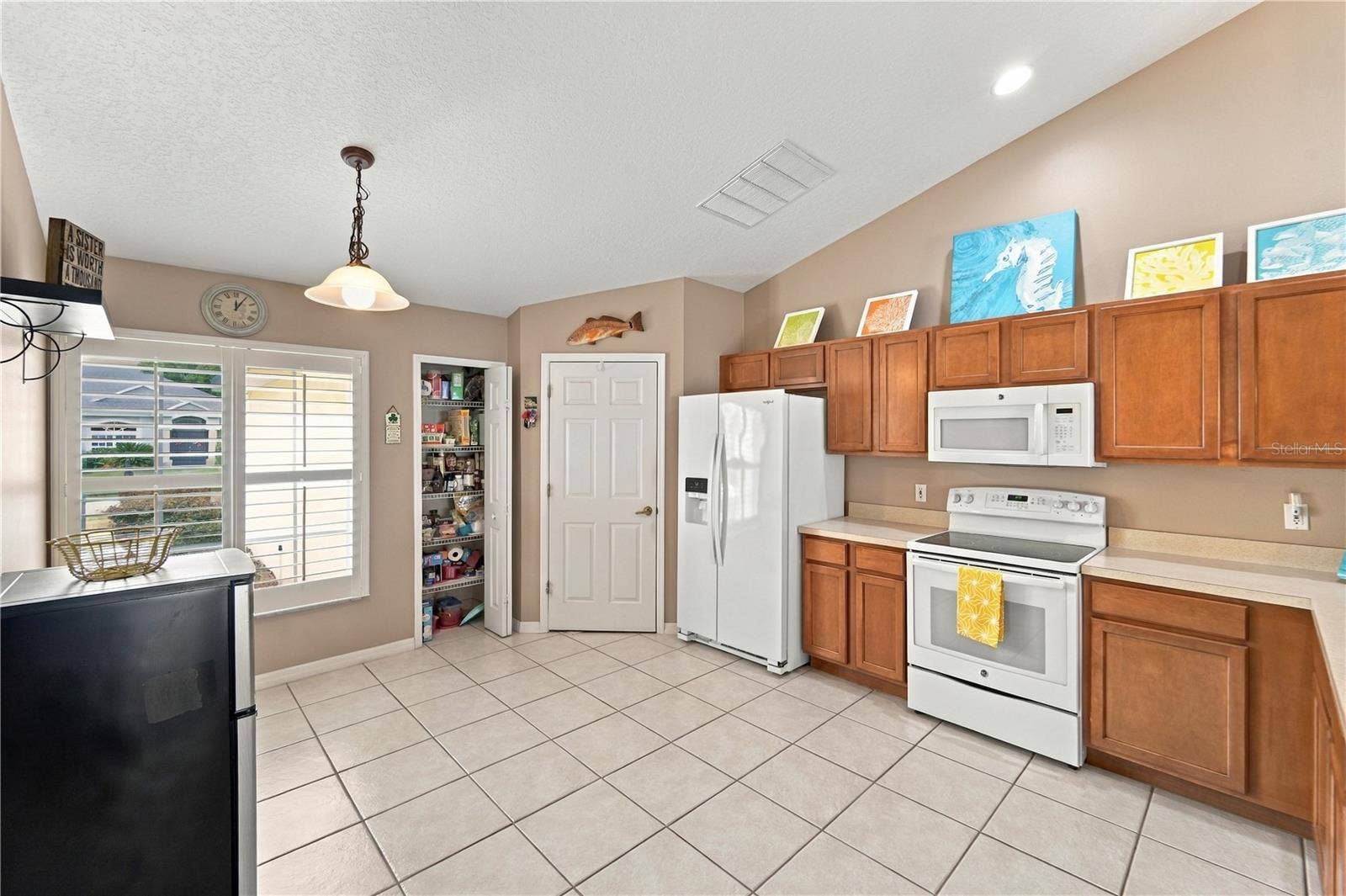 1420 BENT OAKS BOULEVARD, Deland, FL 32724 Spacious kitchen with plenty of cabinets, pantry and room for a breakfast nook table. Closed door is to separate laundry room.