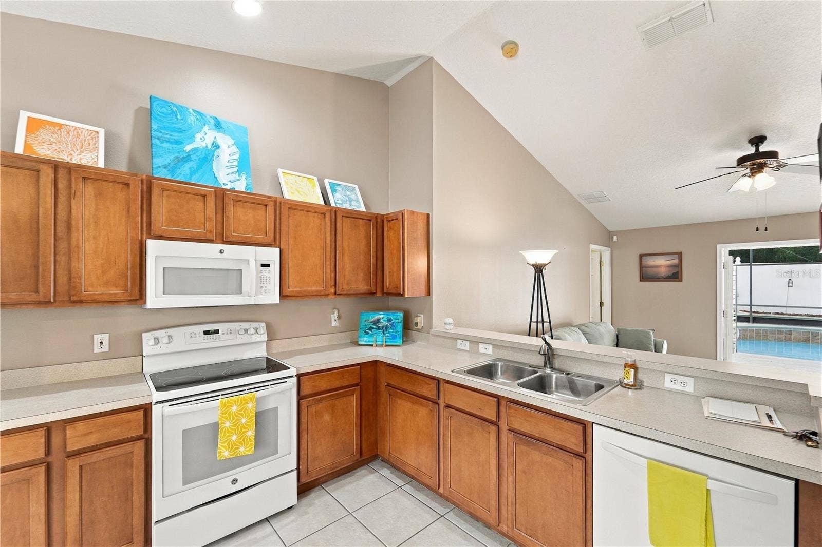 1420 BENT OAKS BOULEVARD, Deland, FL 32724 Kitchen is well designed so you can check on your guests in the pool area