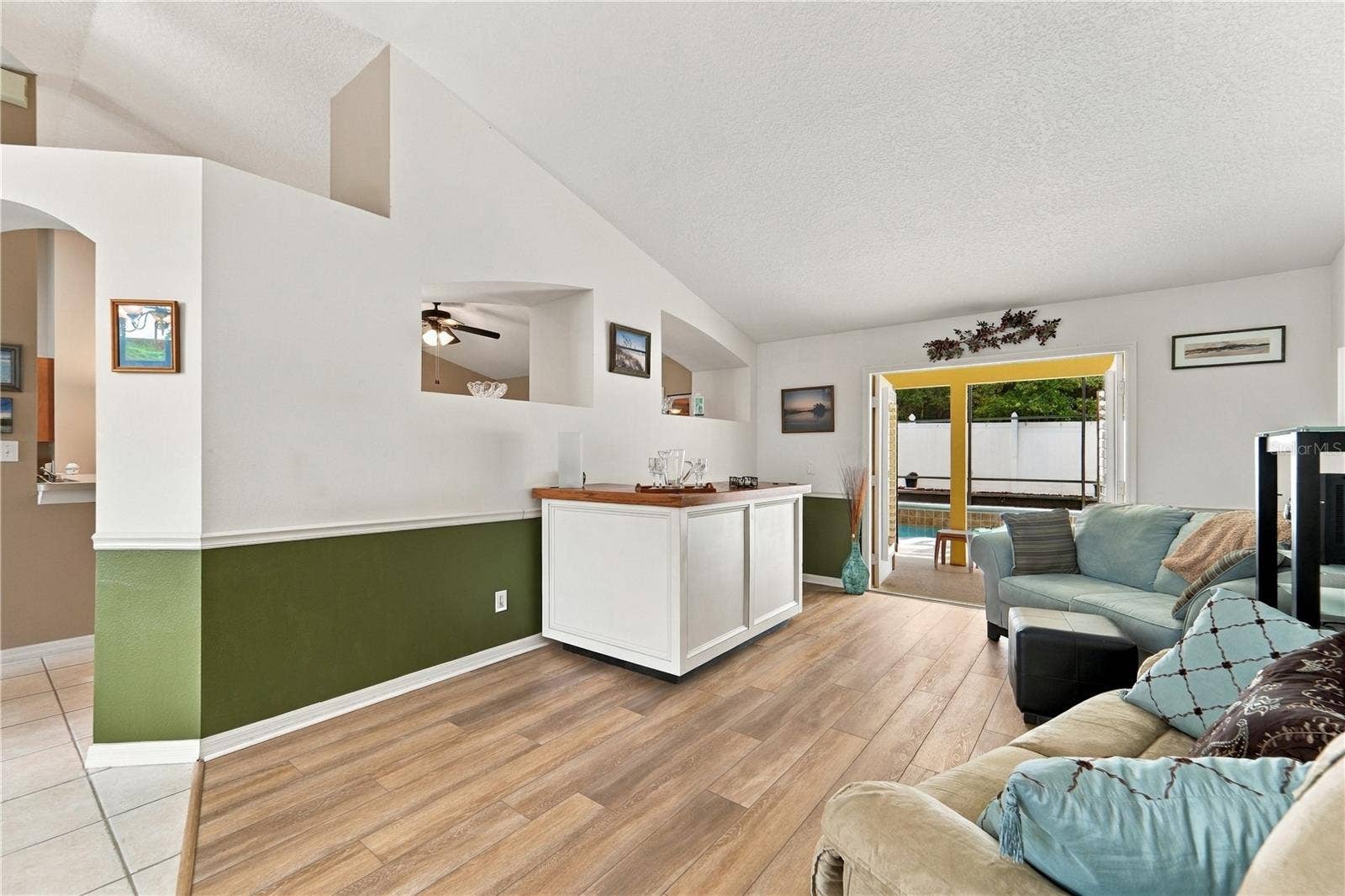 1420 BENT OAKS BOULEVARD, Deland, FL 32724 Living room with French doors out to the pool and screened porch