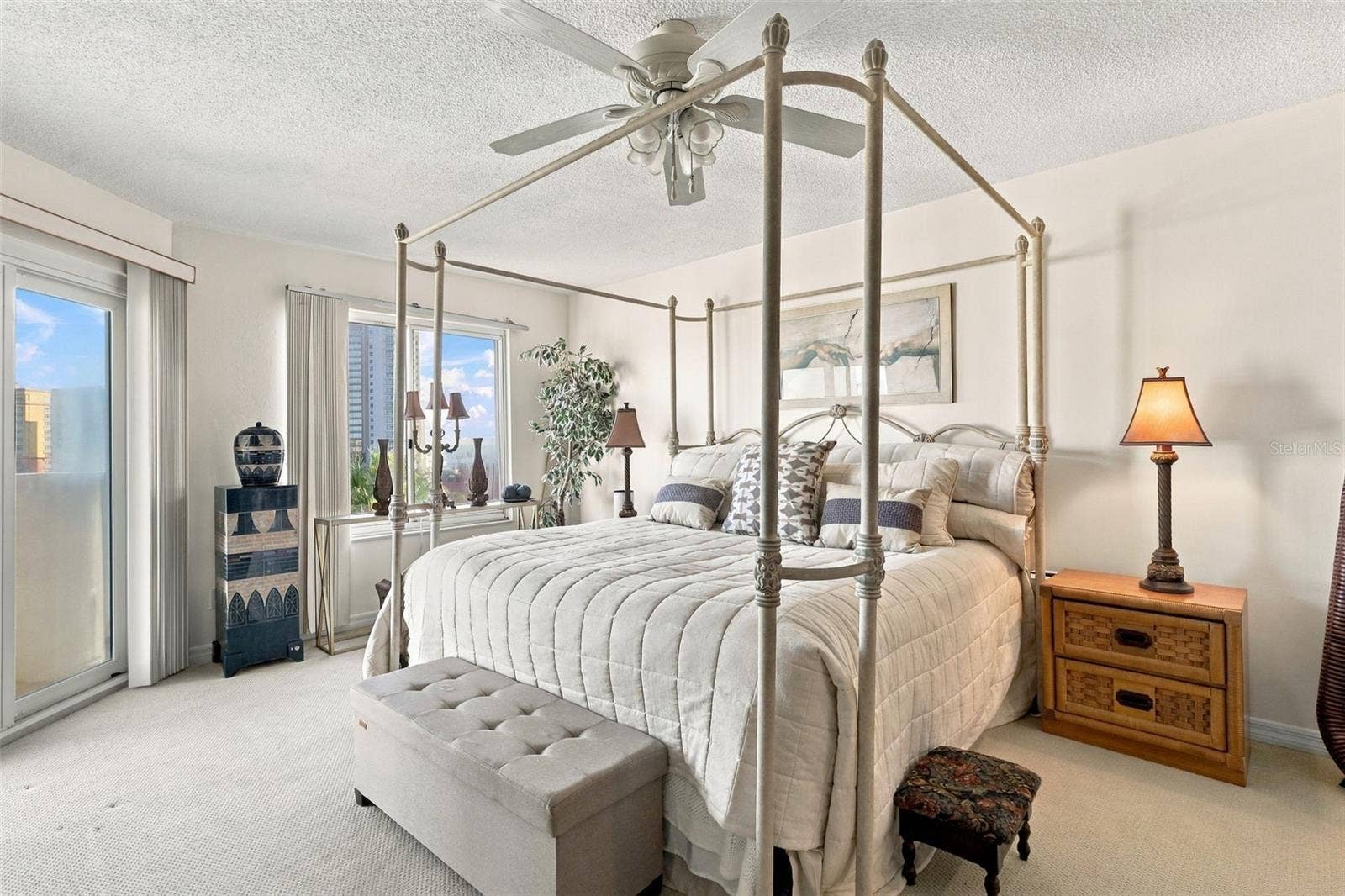 Main level primary bedroom with balcony access and ocean views