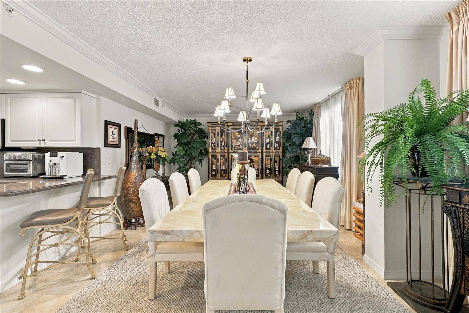 Dining Room features elegant tile and dining table seating 8