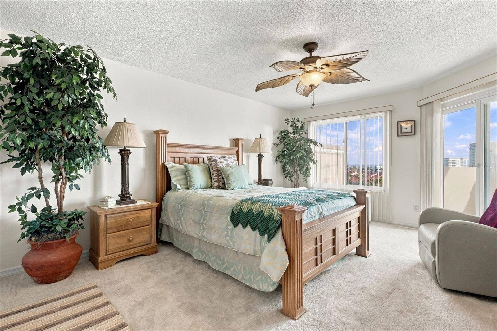 Main level guest bedroom with balcony access and ocean views