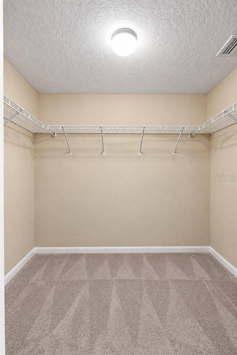 42 BECKNER LANE, Palm Coast, FL 32137 MASTER CLOSET- 1 OF 2- VIRTUALLY STAGED