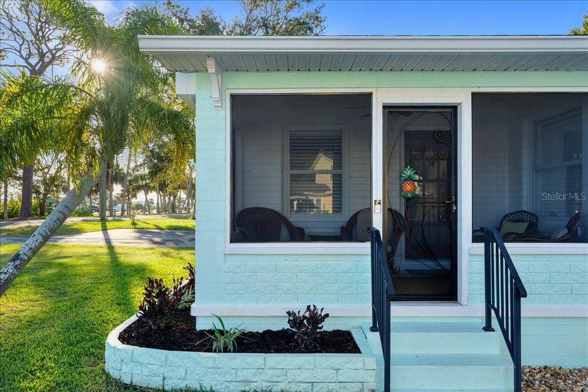 1146 RIVERSIDE DRIVE, Daytona Beach, FL 32117 Screened front porch looks out to Halifax River