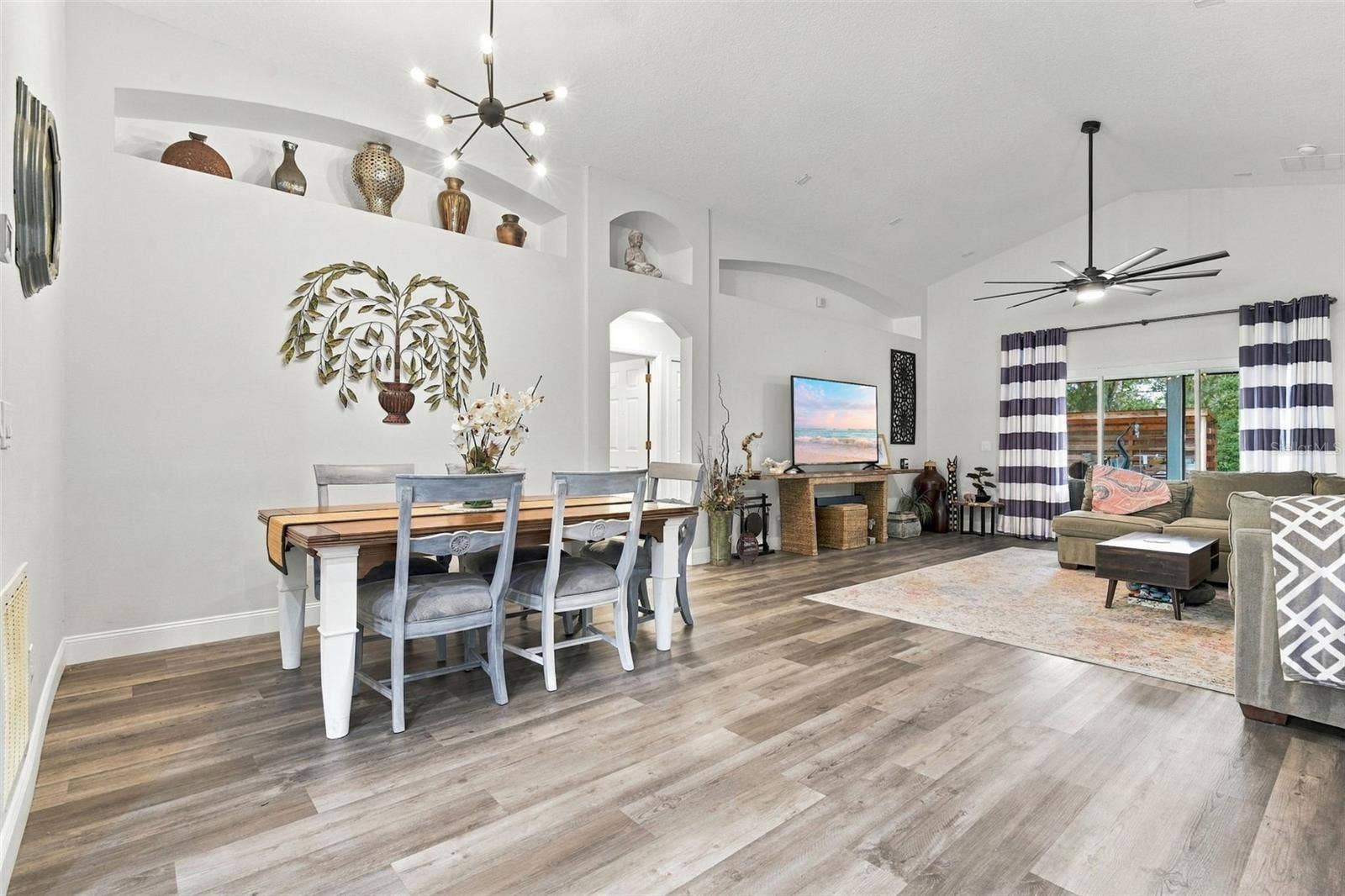 Dining and main living area. These soaring ceilings make it feel larger than it is.
