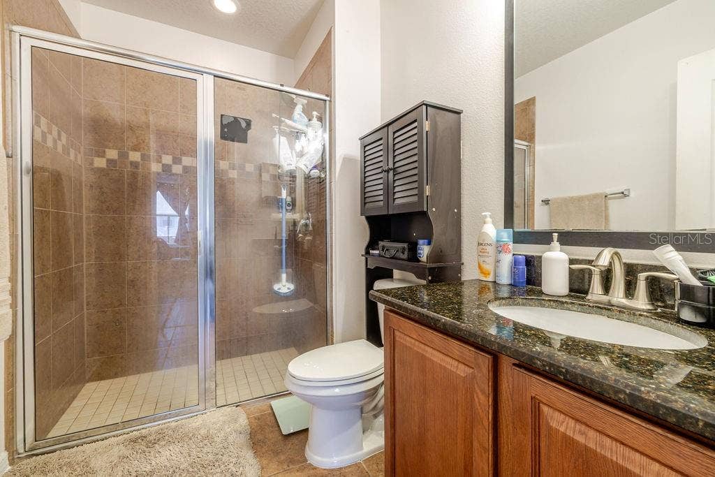 252 SHERRI LEE LANE, Deland, FL 32720 Ensuite bathroom to primary bedroom with tile shower and granite countertops