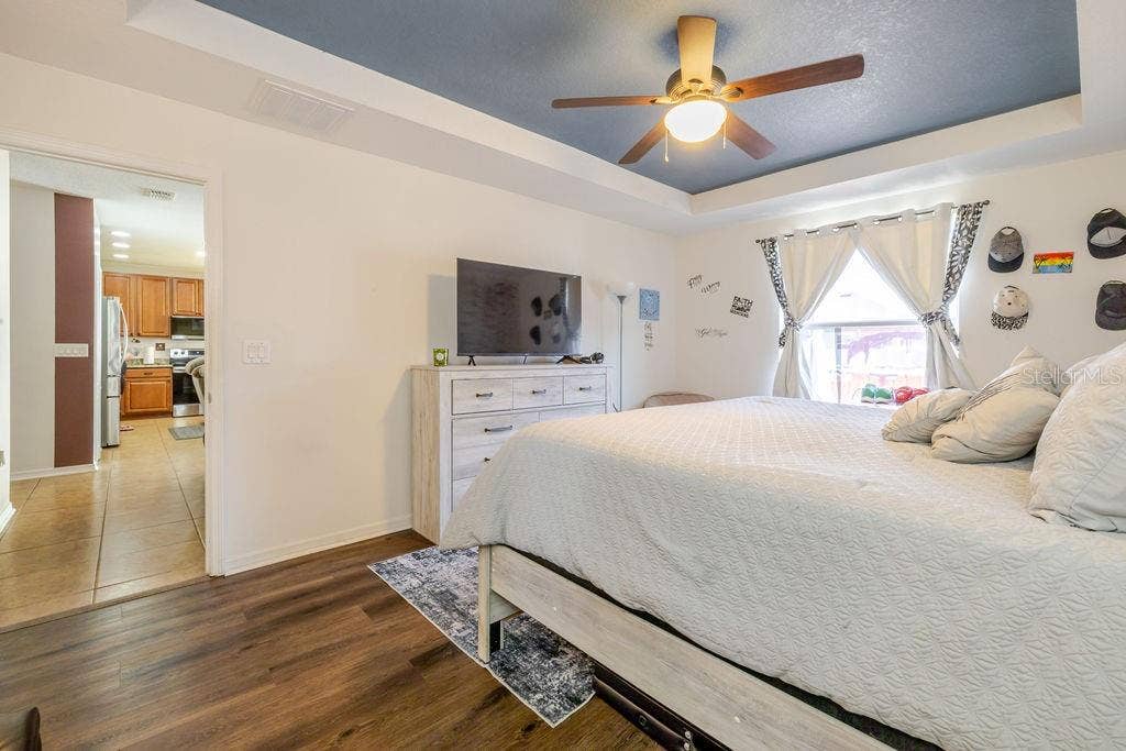 252 SHERRI LEE LANE, Deland, FL 32720 Primary bedroom with ceiling fan and vinyl plank floors