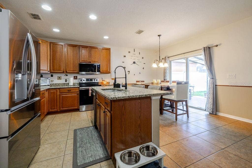 252 SHERRI LEE LANE, Deland, FL 32720 Kitchen and dining area with sliding glass doors to covered back patio