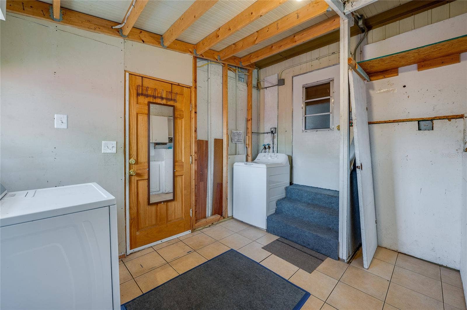 Separate laundry area provides space for laundry appliances along with additional room for household storage and utility needs.