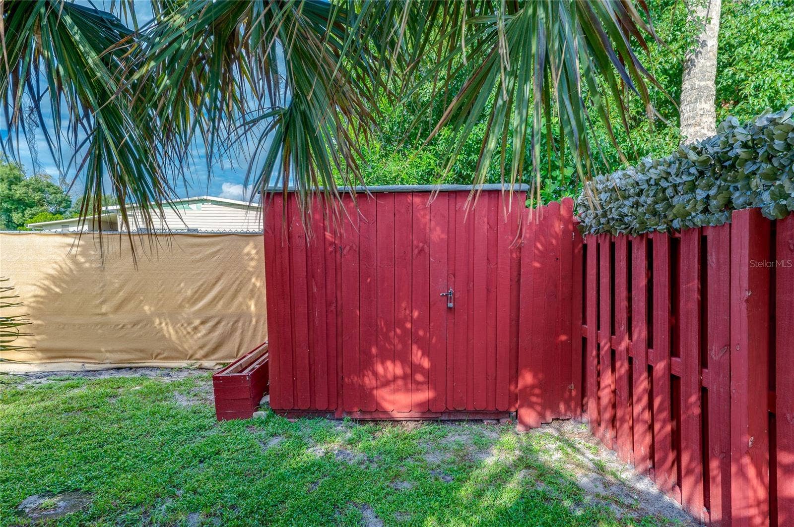 Freestanding storage shed provides a dedicated space for lawn equipment, tools, and other outdoor items, with convenient access from the backyard.