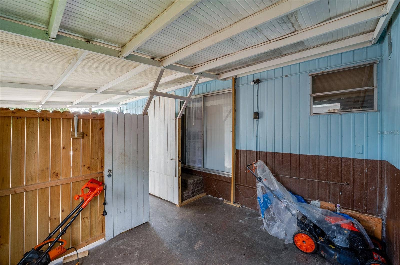 Covered outdoor area provides a sheltered extension of the home with direct access to the interior.