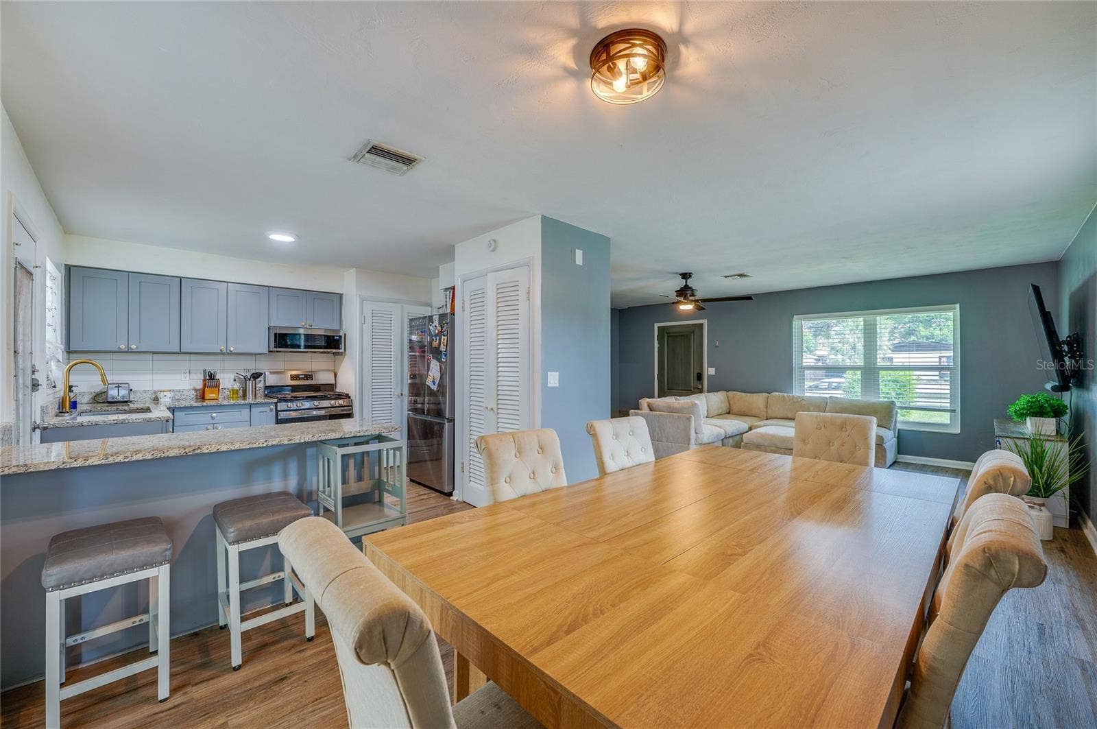 605 E NORMANDY BOULEVARD, Deltona, FL 32725 Open-concept floor plan offering seamless flow between the primary living areas, framed by LVP flooring and overhead lighting.