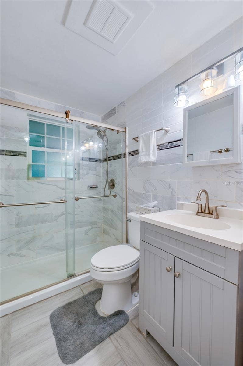 Remodeled bathroom with floor to ceiling tile