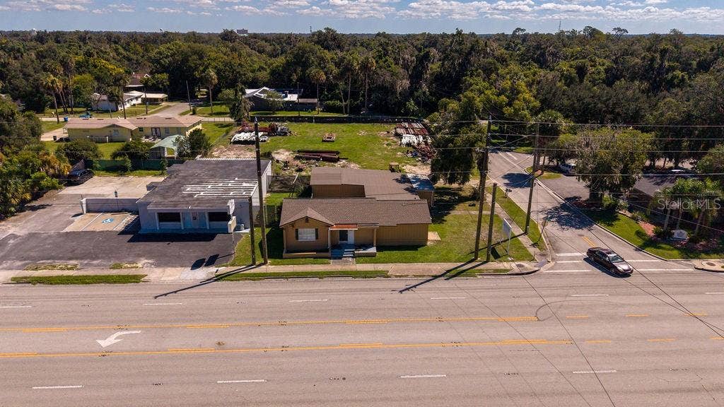 219 S SPRING GARDEN AVENUE, Deland, FL 32720 Aerial of front of building facing major thoroughfare 15-A. Building and vacant lot zoned B4.