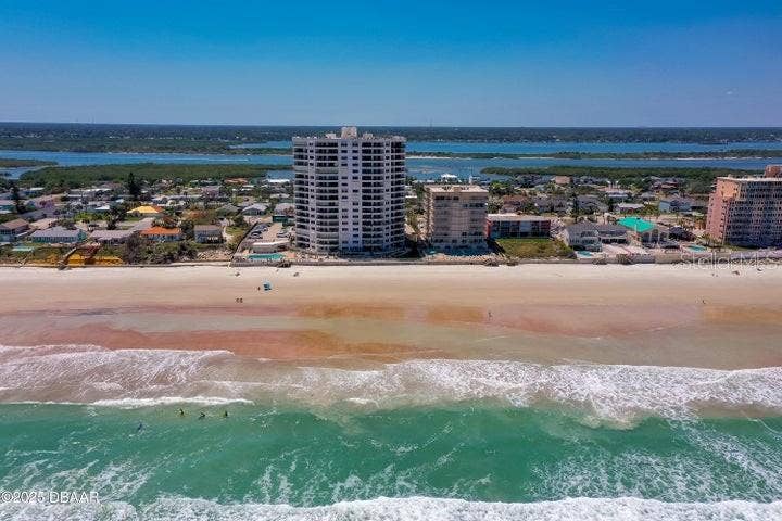 Nestled directly on the sand, this high-rise building boasts unobstructed beach access and expansive shoreline viewsideal for beachfront living.
