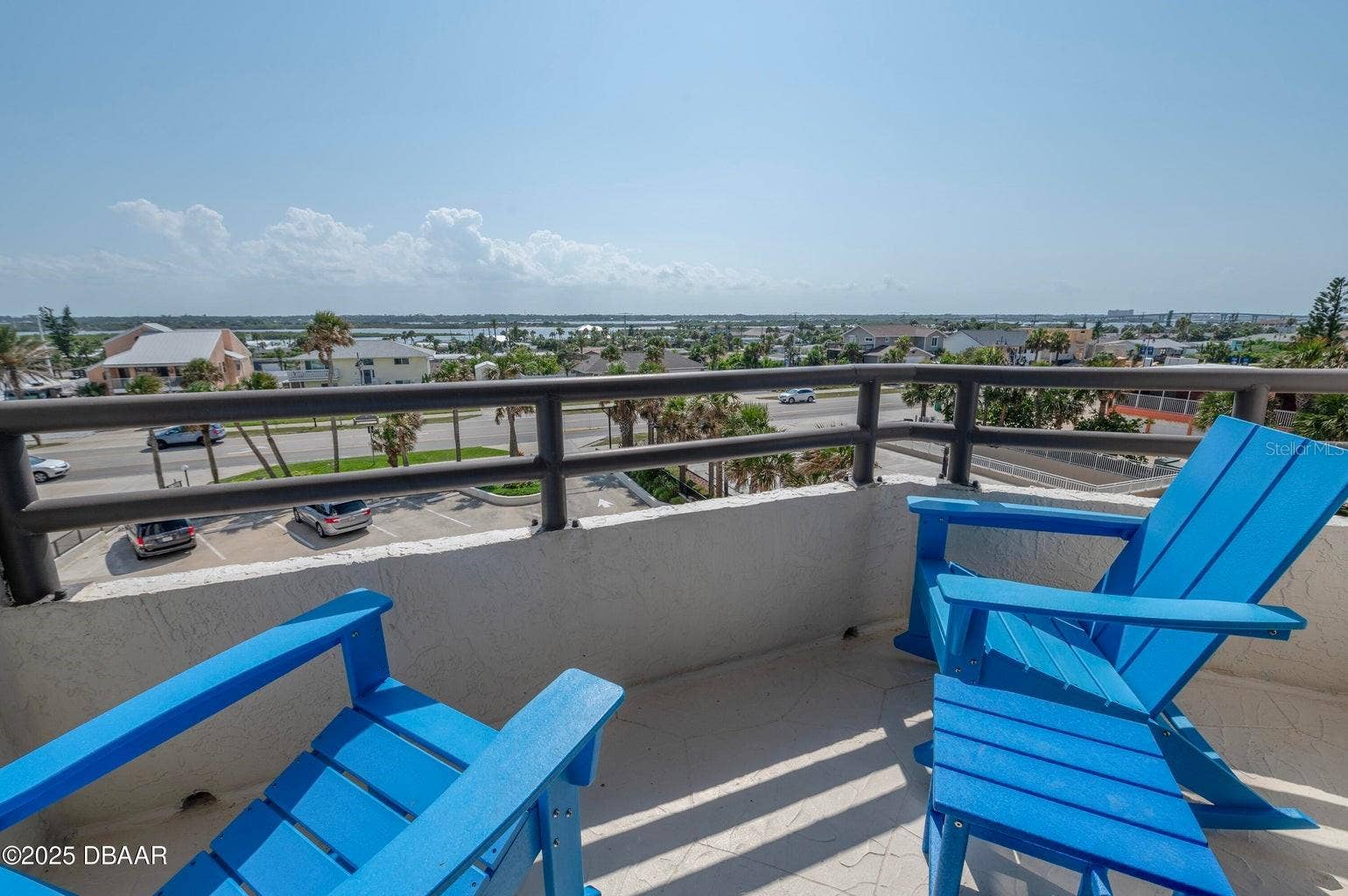 Relax on the private balcony overlooking the surrounding coastal neighborhood, with scenic inland views and comfortable space to enjoy morning coffee or evening breezes.