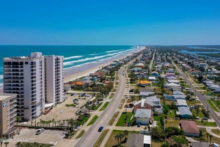 Aerial perspective showcases the vibrant coastal neighborhood and scenic drive north, perfect for bike rides or leisurely strolls.