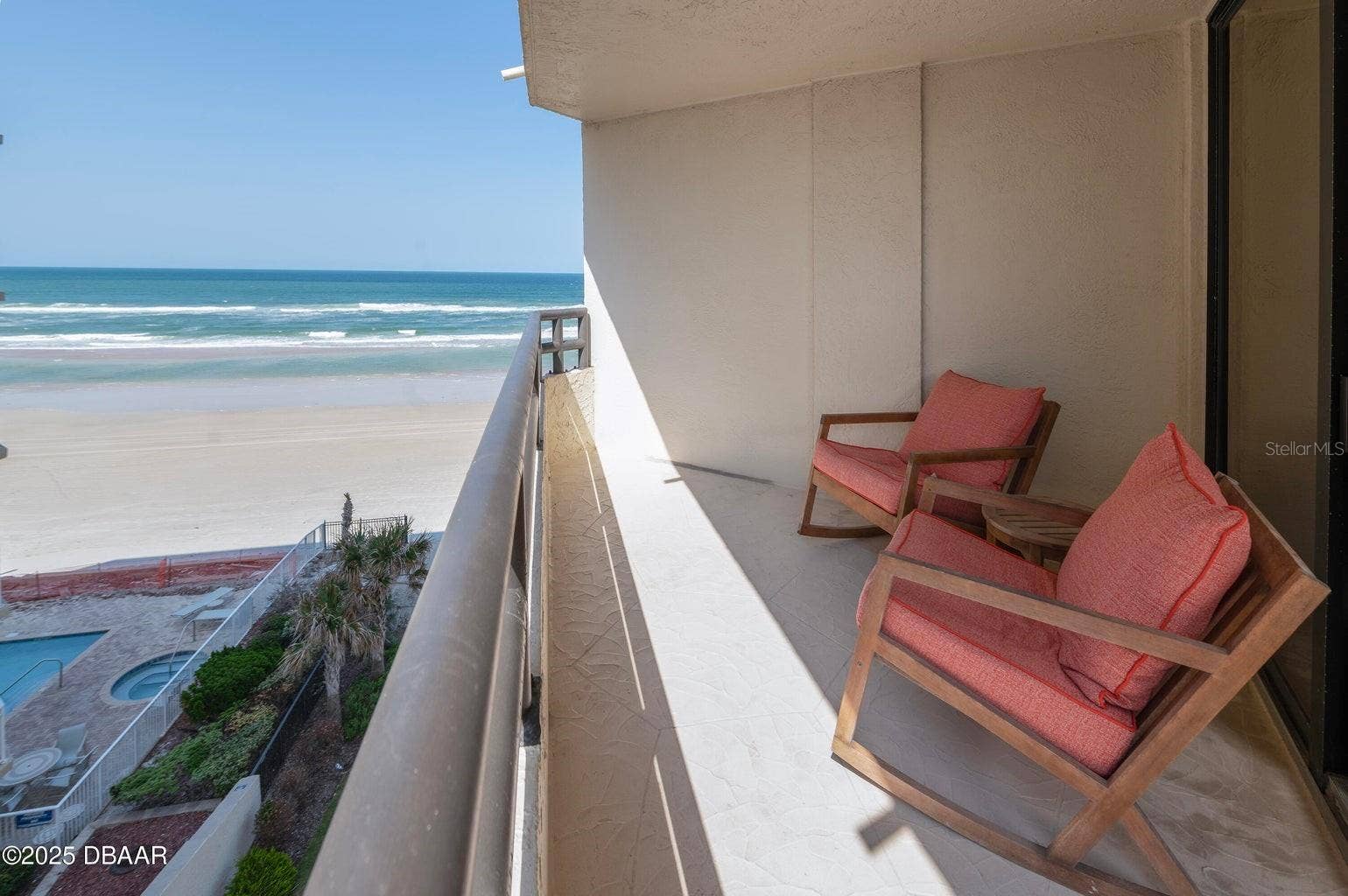Ample balcony space with room for seating, overlooking the pool and beach for a true resort-style experience.