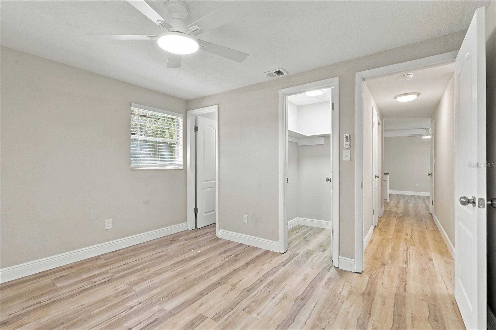 Primary bedroom with walk-in closet.