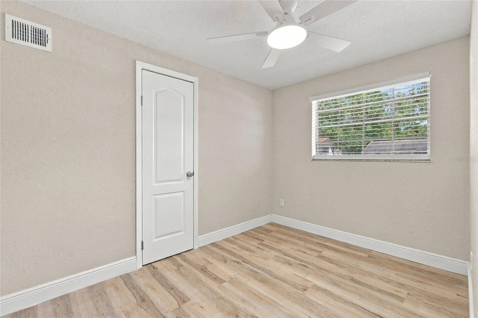 Second bedroom with closet door.