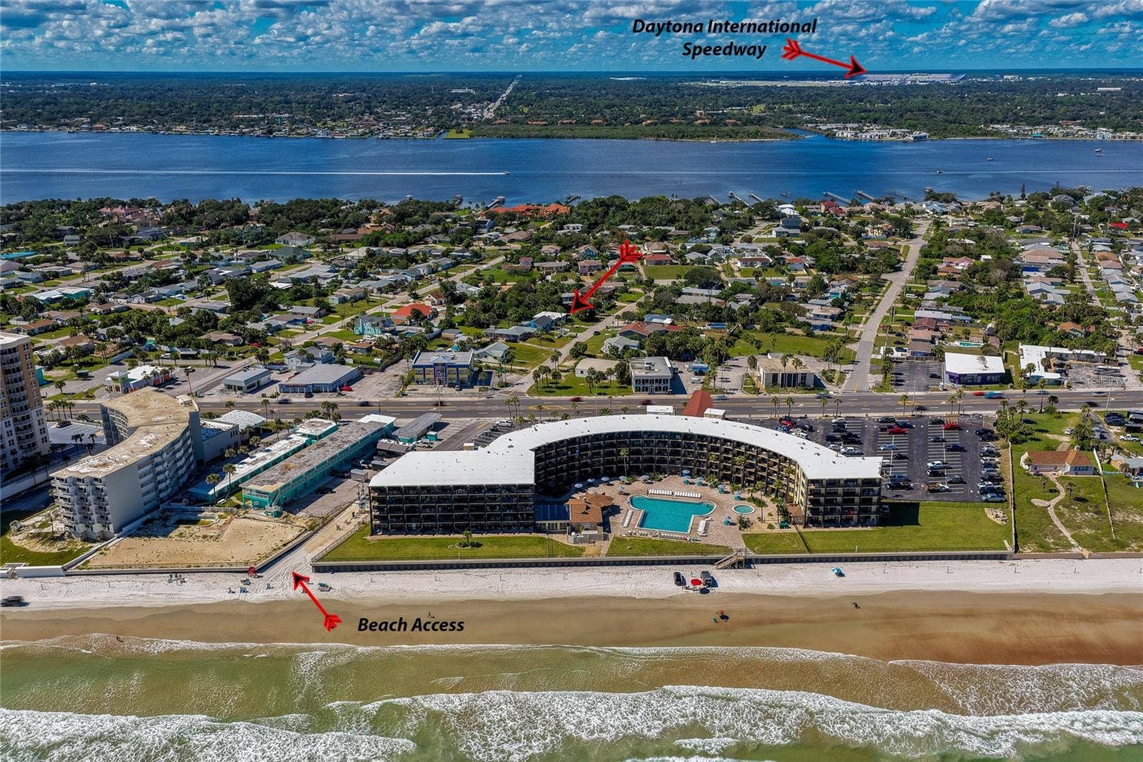 Broad coastal aerial showcase indicating key regional landmarks, including direct beach access routes and the nearby Daytona International Speedway. The surrounding area offers easy access to local amenities and beachside attractions.