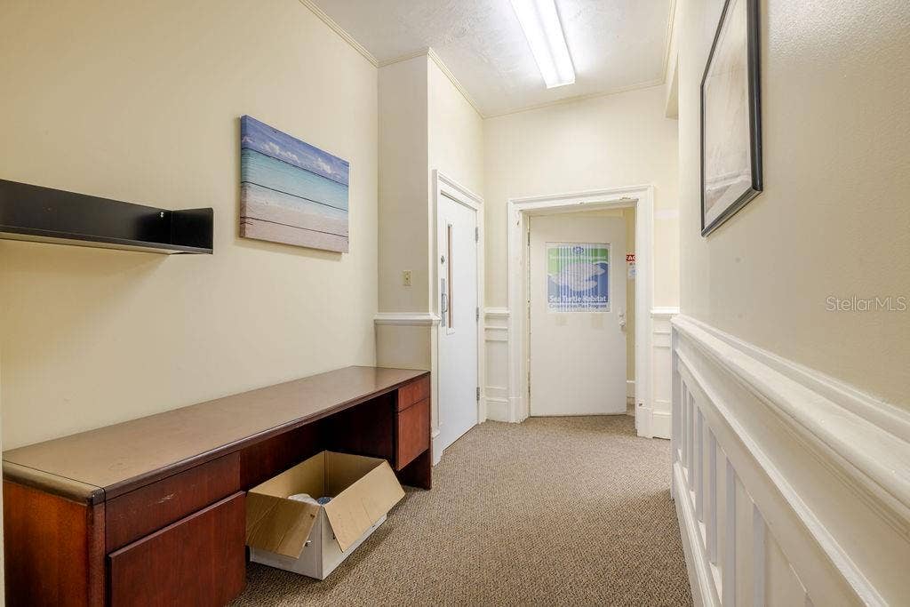 440 S BEACH STREET, Daytona Beach, FL 32114 First floor hallway leading to West side of property and interior basement door.