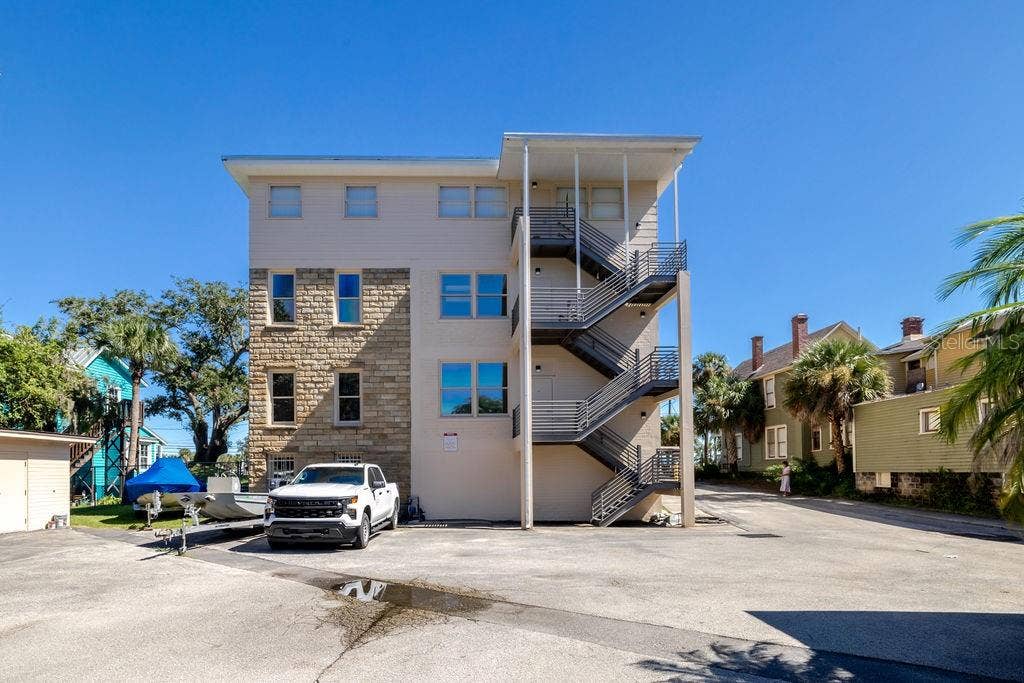 440 S BEACH STREET, Daytona Beach, FL 32114 Back of building from the West, highlighting newly constructed block and metal fire escape. spanning all 3 floors.