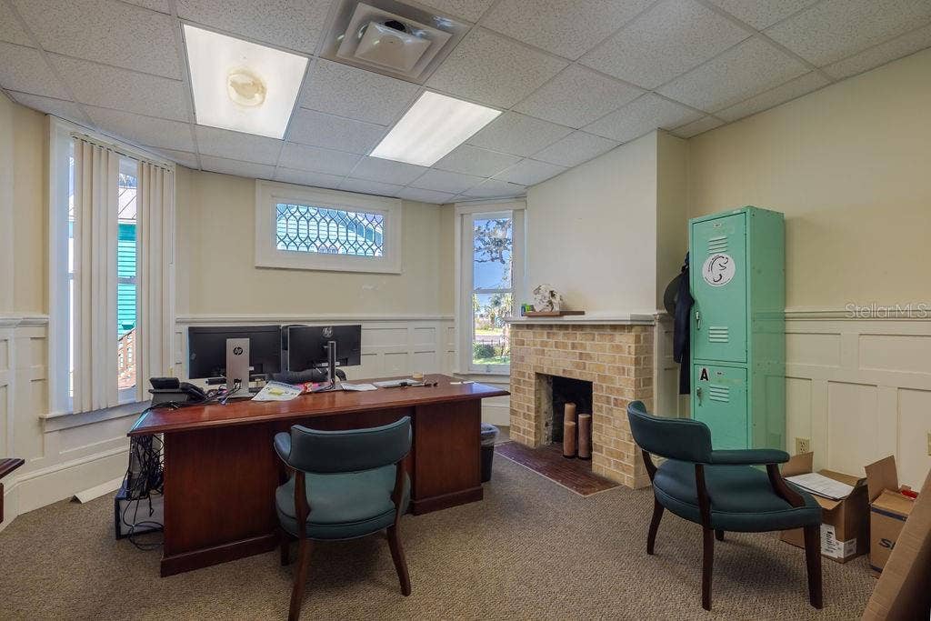 440 S BEACH STREET, Daytona Beach, FL 32114 First floor office with stained glass accent window and historic masonry fireplace.