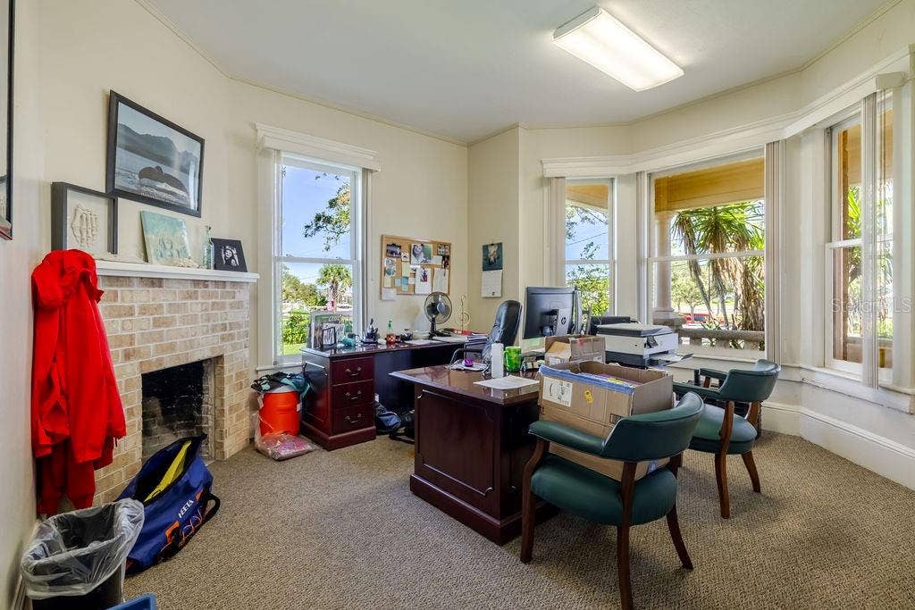 440 S BEACH STREET, Daytona Beach, FL 32114 First floor office with oversized historic bay window facing the Halifax river. Historic masonry fireplace.
