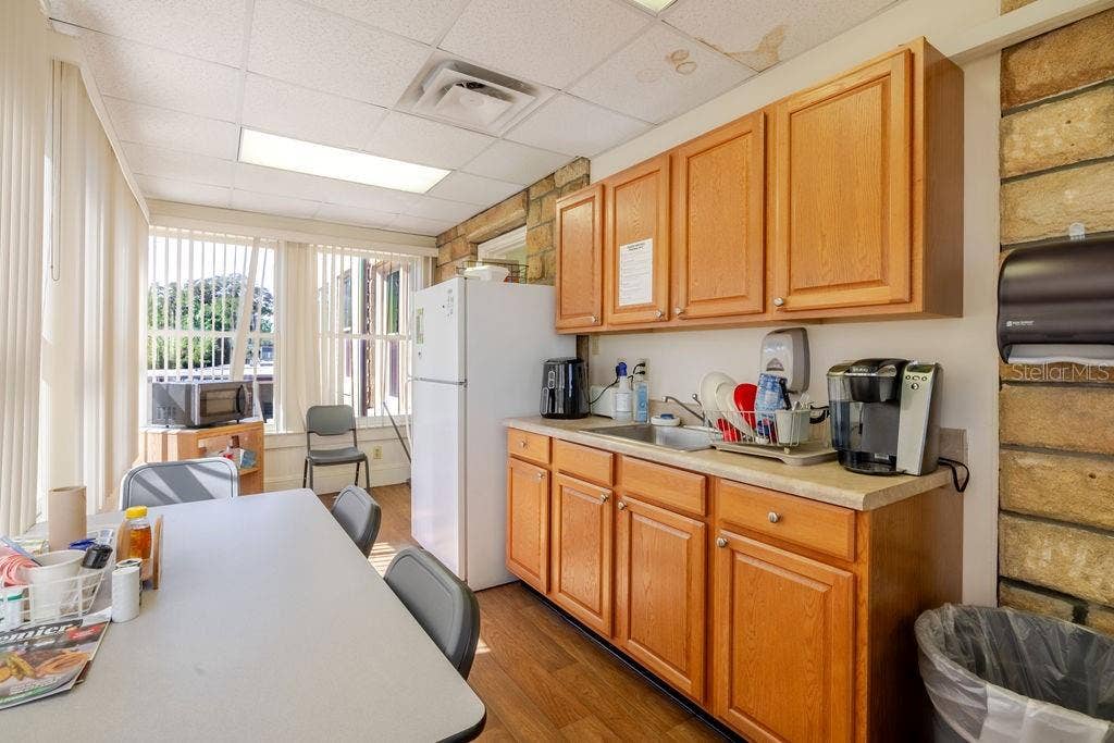 440 S BEACH STREET, Daytona Beach, FL 32114 First floor kitchen with wrap around windows and exterior access.