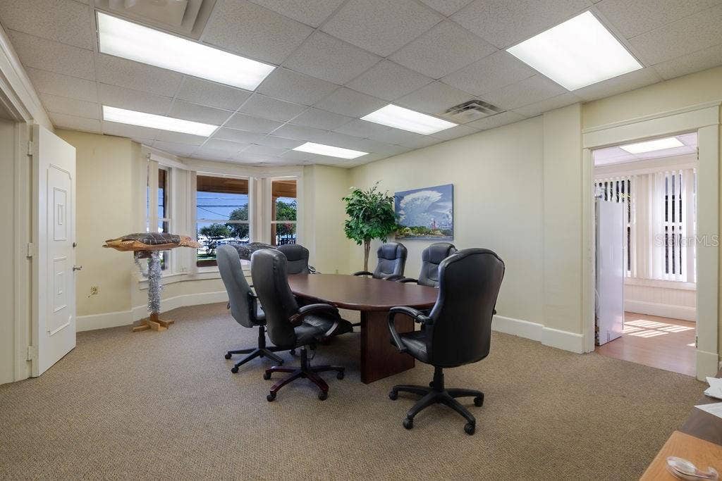 440 S BEACH STREET, Daytona Beach, FL 32114 First floor conference room and previous living area with bay window overlooking the Halifax river.