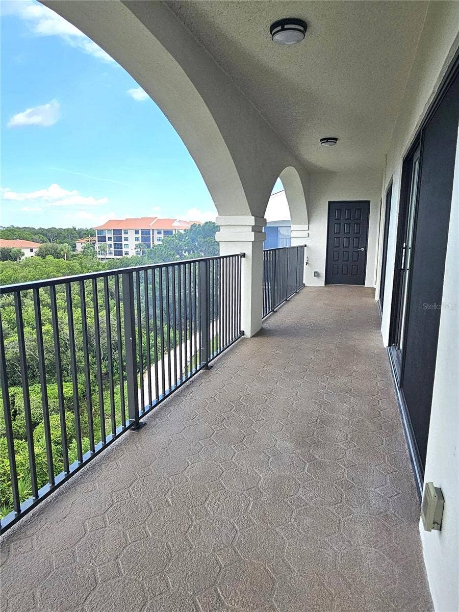243 MARINER DRIVE, #243, Tarpon Springs, FL 34689 Side Balcony Showing 1 of 2 A/C Storage Rooms