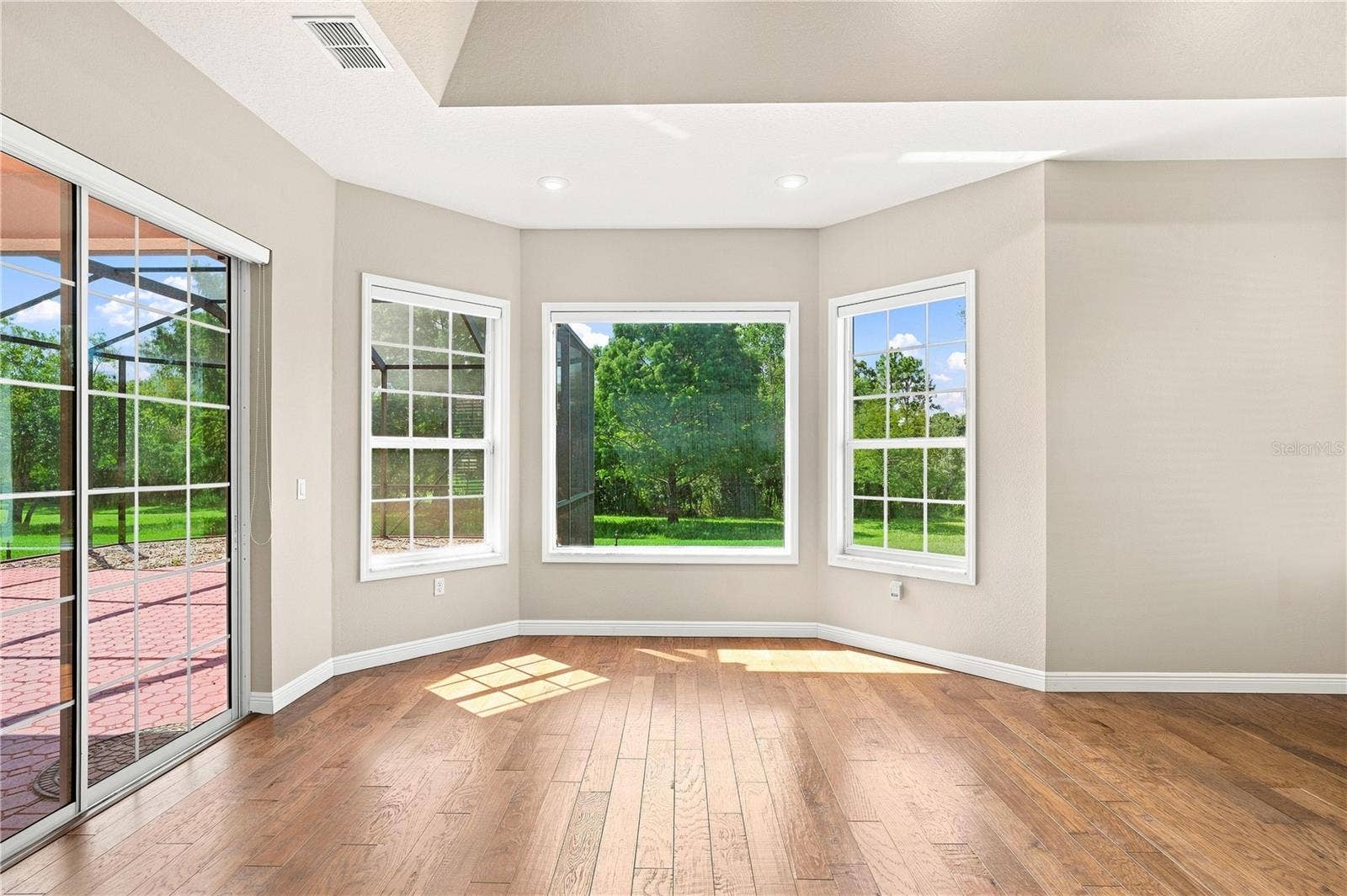 8698 MISSISSIPPI RUN, Weeki Wachee, FL 34613 Primary Bedroom sitting area with view back private garden