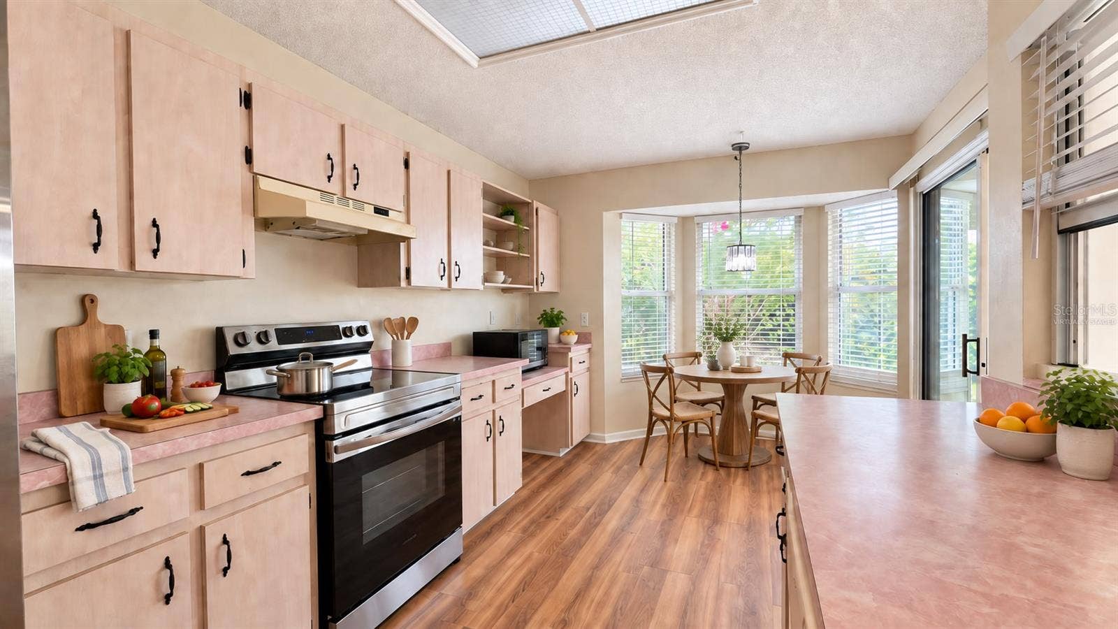 6501 SW 84TH PLACE ROAD, Ocala, FL 34476 Large kitchen with breakfast room facing the backyard. Virtually staged.