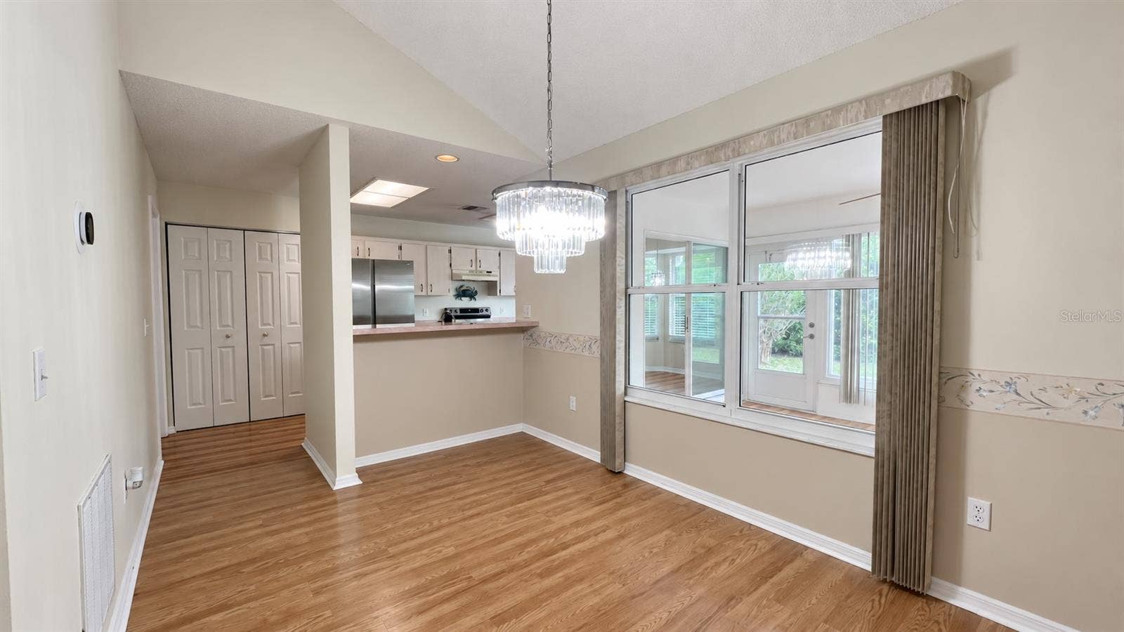 6501 SW 84TH PLACE ROAD, Ocala, FL 34476 Dining room leading into the large kitchen and facing the enclosed lanai.