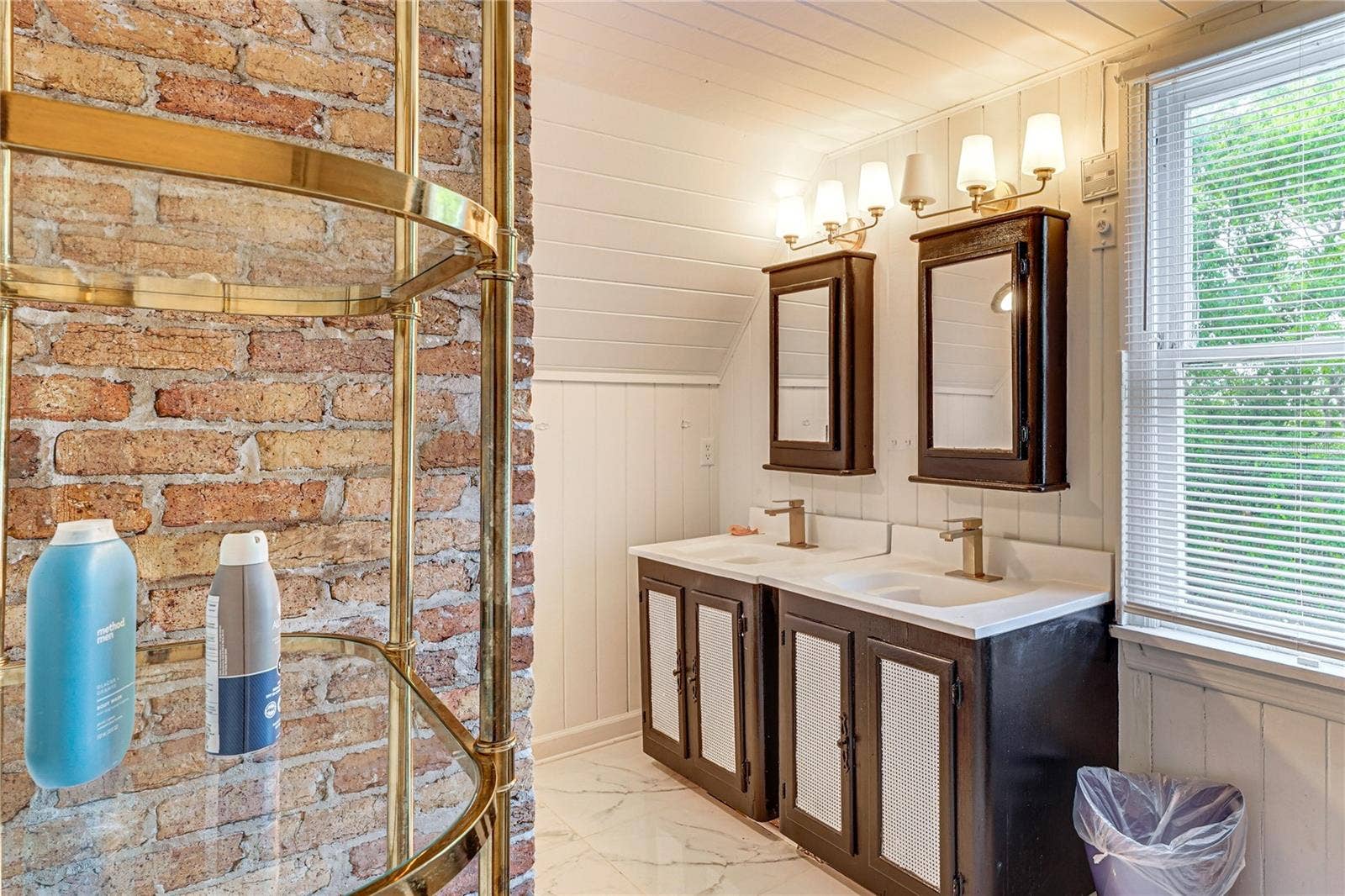 743 E FORT KING STREET, Ocala, FL 34471 Bathroom with Double Vanity and Exposed Brick