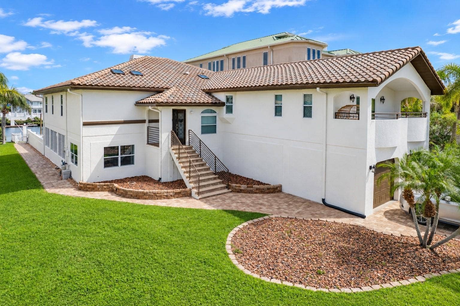 5226 WESTSHORE DRIVE, New Port Richey, FL 34652 Side exterior of the elevated home with stairs to the main entry.