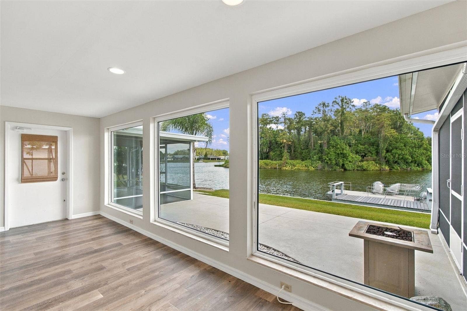1615 BUNKER HILL DRIVE, Sun City Center, FL 33573 FAMILY ROOM VIEW, Back patio, screened porch on each side.